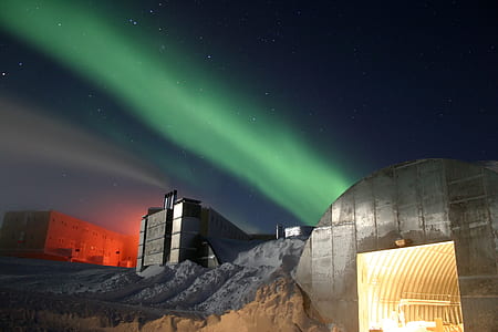 green lights coming at the back of gray building thumbnail