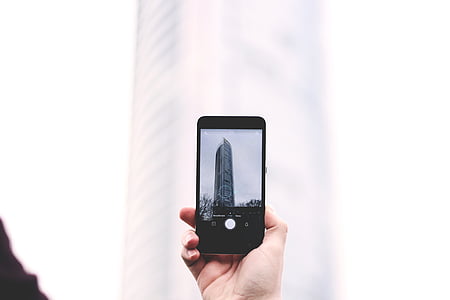 person taking photo of building thumbnail