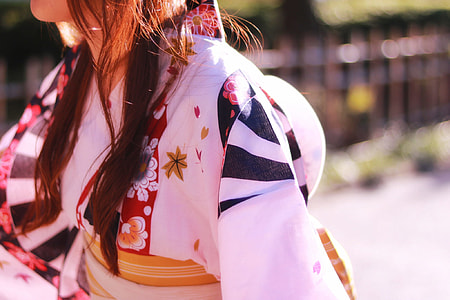 brown haired woman wearing white, red and black kimono during daytime thumbnail