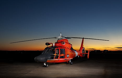 red helicopter on gray pavement thumbnail