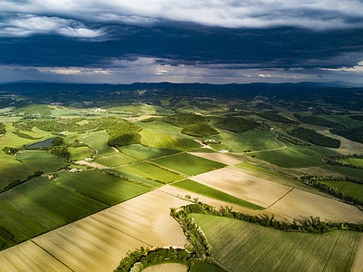 aerial view of grass and soil covered field during day thumbnail