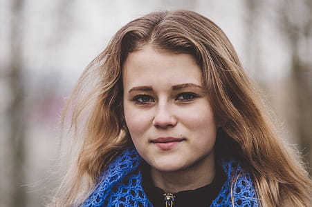 Selective Focus Photo of Woman Wearing Knitted Blue and Black Top thumbnail