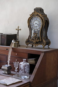 analog mantel clock on wooden desk thumbnail