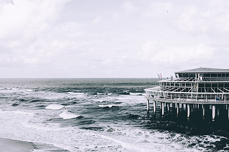white building on seashore at daytime thumbnail