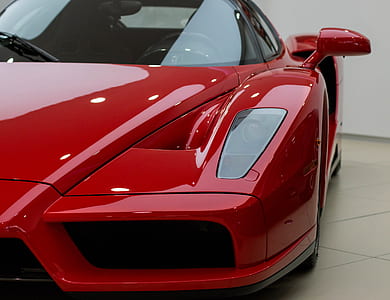 red Ferrari sports car inside showroom thumbnail