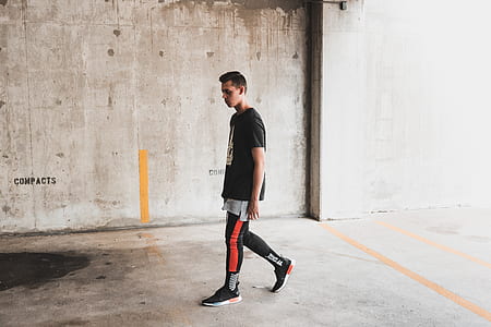 man in black T-shirt walking thumbnail