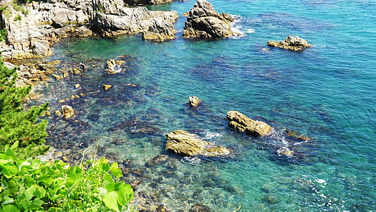 rock formation surrounded of body of water thumbnail