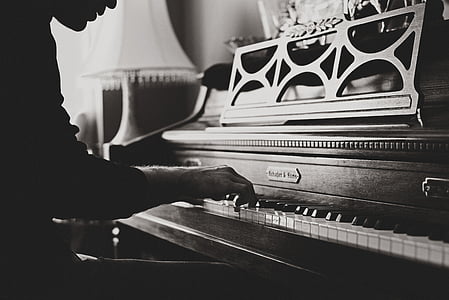 grayscale photography of person playing console piano thumbnail