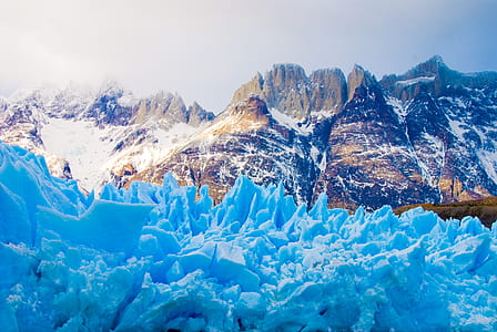 snowfield near mountains during daytime thumbnail