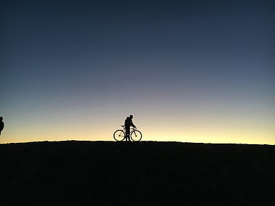silhouette photography of a person riding bicycle thumbnail