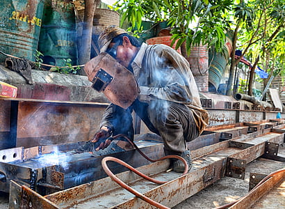 man holding welding mask thumbnail