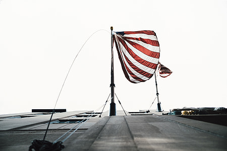 white and red striped flag with pole at daytime thumbnail