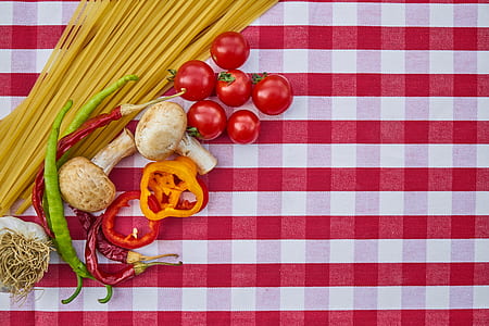 red tomatoes on white and red tablecloth thumbnail