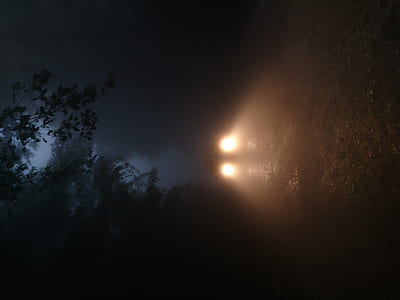 vehicle headlights in dark road photo thumbnail