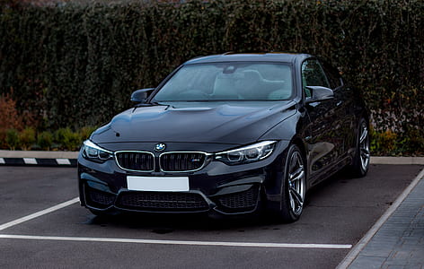 black BMW sedan parked at parking space thumbnail