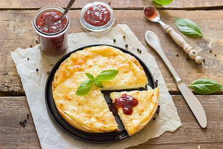 macro shot of omelet dish beside red spread thumbnail