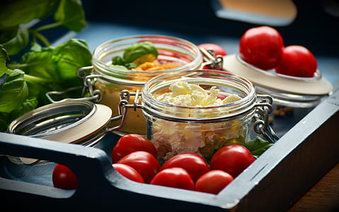 selective focus photo of vegetables in clear glass jars thumbnail