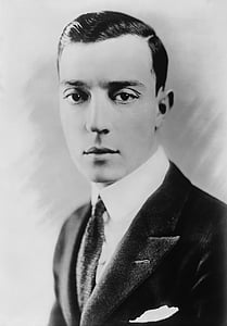 grayscale photography of man wearing black suit thumbnail