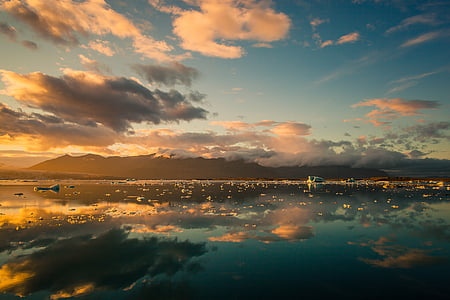 ocean under gray and white clouds during sunset thumbnail