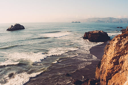 brown rock formation near body of water thumbnail