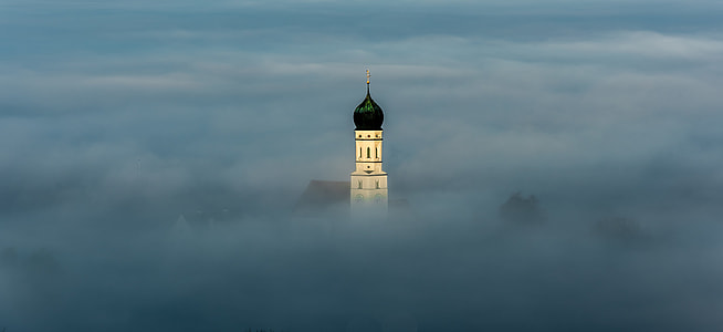 landscape photography off tower covered by clouds thumbnail