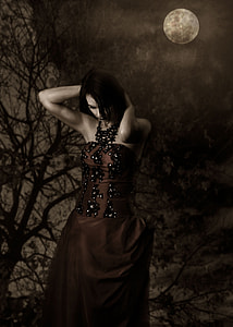 woman wearing brown and black dress holding her head under full moon thumbnail