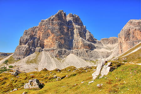 landscape photo of brown mountain near field thumbnail