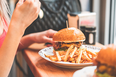 Woman Preparing to Eat Big Bacon Burger thumbnail