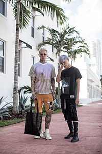 two man standing close together on brown pathway thumbnail