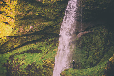 man standing on mountain with falls thumbnail
