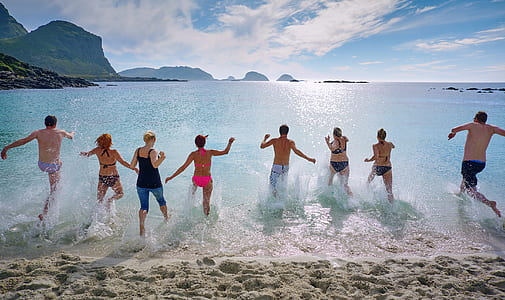 eight people walking towards sea during daytime thumbnail