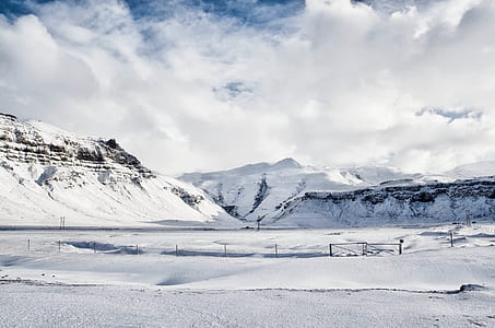 photo of glacier mountains under cloudy sky thumbnail