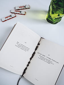 book near green drinking glass thumbnail