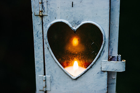 candle reflected on heart mirror with white frame thumbnail