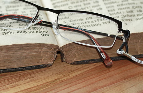 black and brown framed eyeglasses on book thumbnail