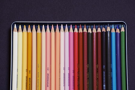 high angle photography of color pencil set on case thumbnail