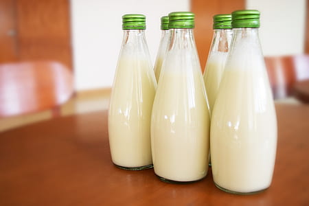 five bottles of milks on table thumbnail
