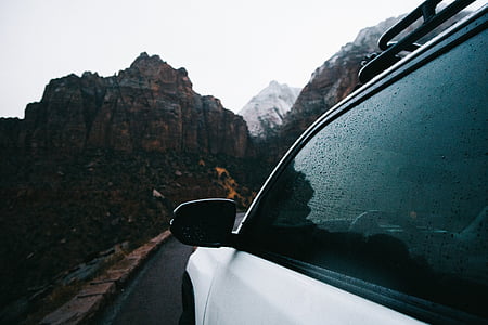 white vehicle cruising on black road thumbnail