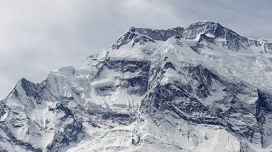 snowcapped mountain under gray sky thumbnail