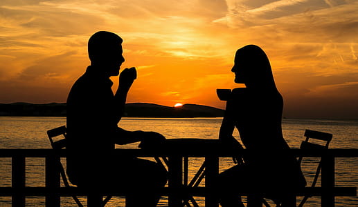 Photo illustration of a couple sitting outside in the sunset, sipping coffee thumbnail