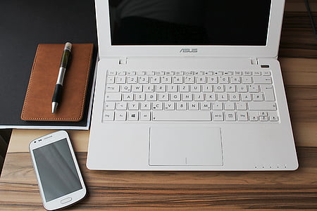 white Asus laptop beside white Samsung smartphone thumbnail