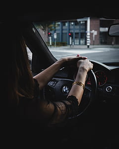 woman holding steering wheel while driving thumbnail