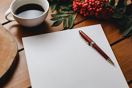 Red rowan fruit with a coffee and a white sheet of paper thumbnail