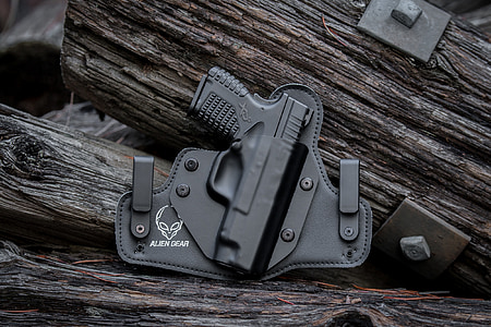 black pistol on black holster thumbnail