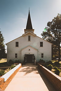 Two Person Standing Near White Church thumbnail