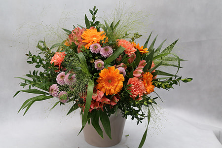 orange and pink Chrysanthemum flower centerpiece on white textile thumbnail