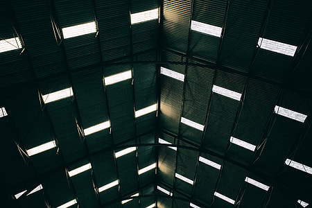 Wide angle shot of light patterns coming through the roof of a large building at Chatham Dockyard in Kent, England thumbnail