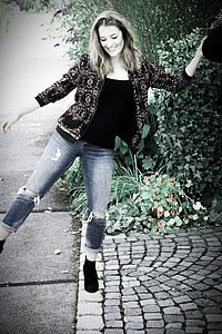 woman in gray jacket and blue distressed jeans near sidewalk thumbnail