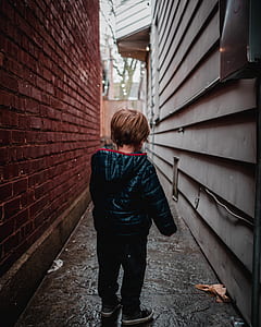 boy standing in middle of alleyway thumbnail