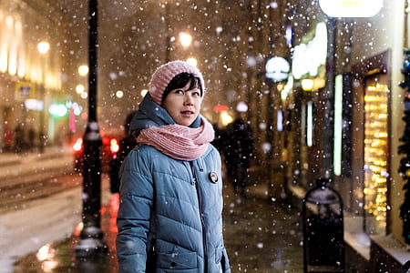 woman wearing parka jacket under the snow thumbnail